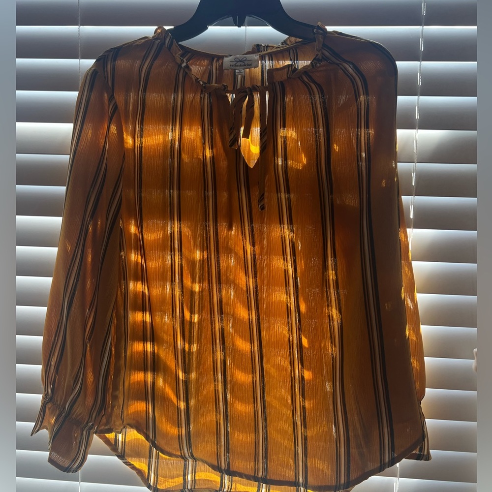 Stylish yellow shirt with stripes and tie at collarbone